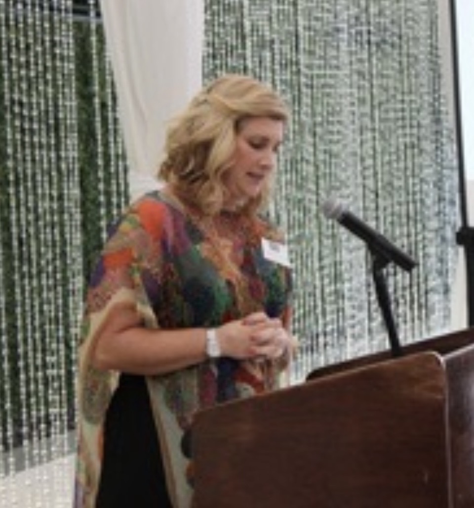 Dr Gabrielle Morrissey speaking at a conference lectern