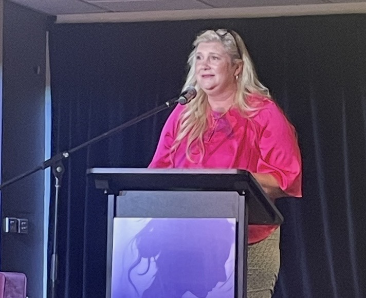 Dr Gabrielle Morrissey addressing an audience from a podium