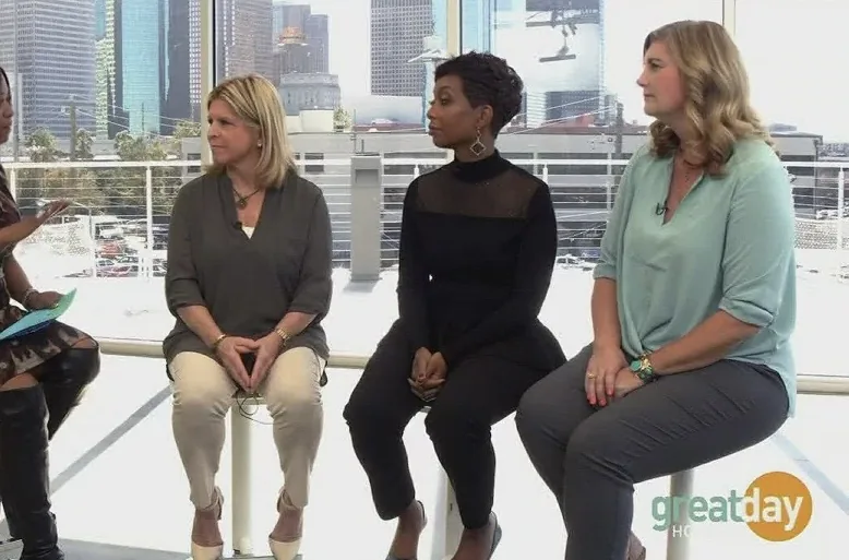 Dr Gabrielle Morrissey on the Great Day Houston rooftop expert panel with the Houston skyline behind