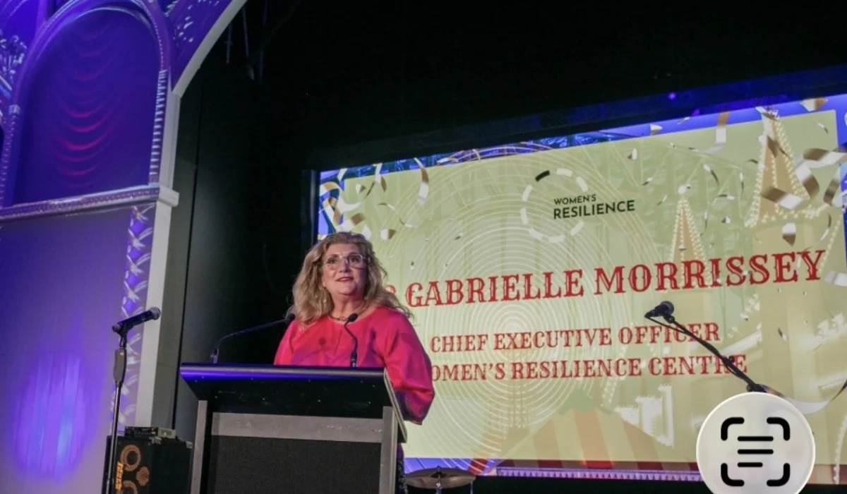 Dr Gabrielle Morrissey at a podium in front of a Women's Resilience Centre title slide naming her as Chief Executive Officer